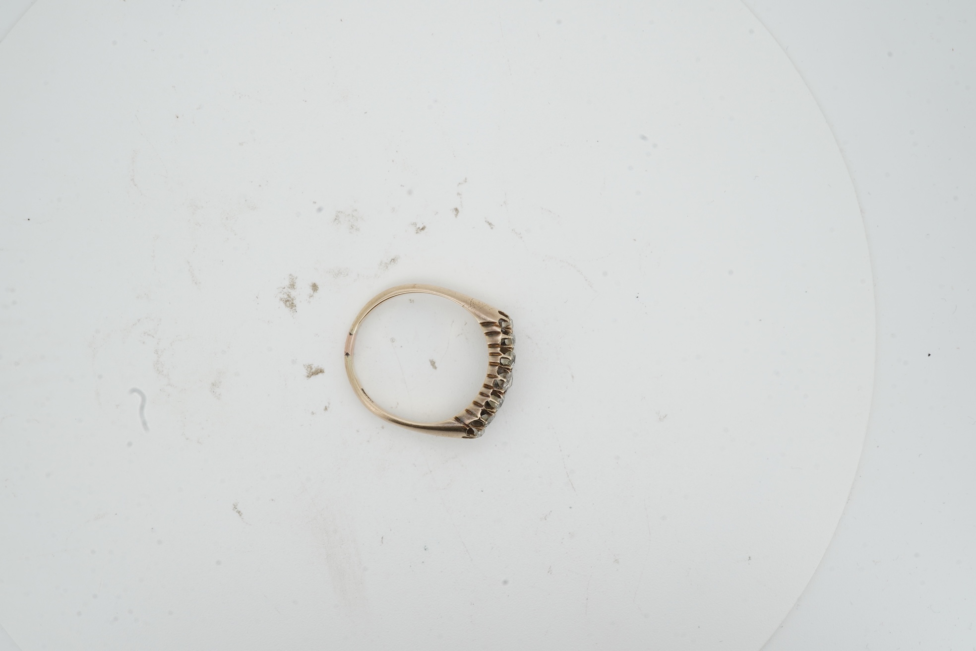 A diamond ring, early 20th century, pavé-set to the front with two rows of cushion-shaped diamonds totalling approximately 0.40 carats, mounted in gold, size O, gross weight approximately 3.5 grams